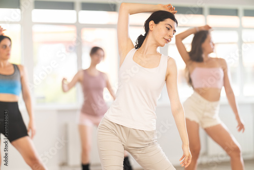 Girls and female friends perform dance in high heels during workout in choreographic studio. Students learn to move to beat of music and combine rhythm and smooth movements. Free Download Girls and female friends perform dance in high heels during workout in choreographic studio. Students learn to move to beat of music and combine rhythm and smooth movements. - GFXLoad