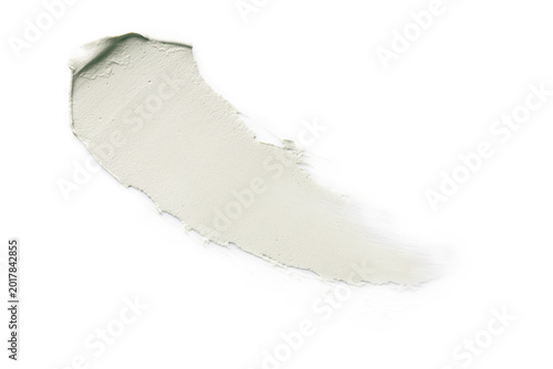 Curved light green cosmetic cream smear on white background.