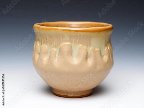 Textured stoneware cup with an organic, lumpy silhouette and earthy glaze tones,  earthy,  unique