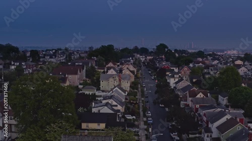 Twilight aerial view of suburban town of East Rutherford in New Jersey, USA with Meadowlands and Manhattan skying in the distance