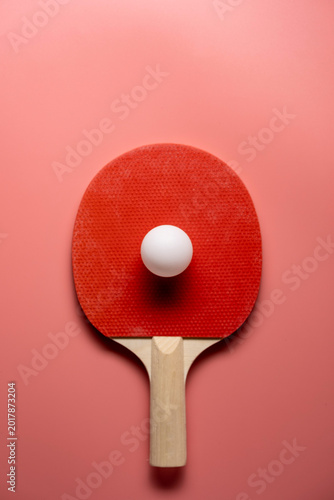 Ping pong rackets and balls on pink background, flat lay