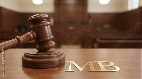 A close-up shot of a wooden gavel and the letters 