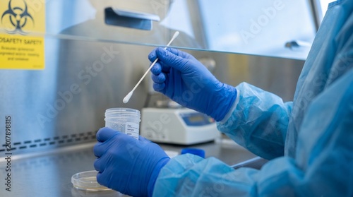 Healthcare worker collecting environmental sample for infectious disease analysis, representing biosafety and clinical investigation in modern healthcare settings
