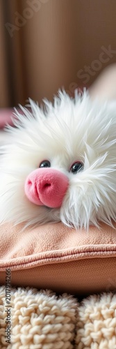 Furry ball of white fluff with bright pink nose and sparkling eyes lounging on a soft cushion, pink, nose