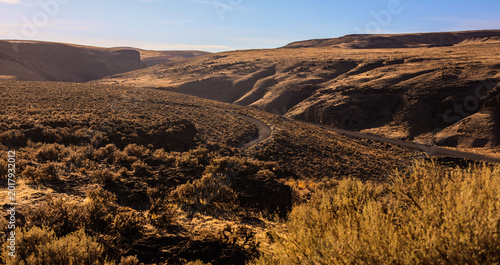 Bild auf Leinwand Winding Road Through the Rugged Basalt Canyons and High Desert Shrubland of Gink