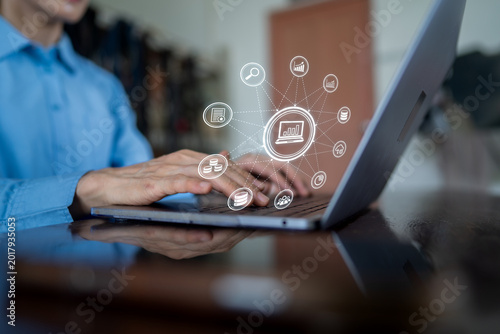 Business Data Analysis and Digital Marketing Strategy via Laptop with Tech Icons