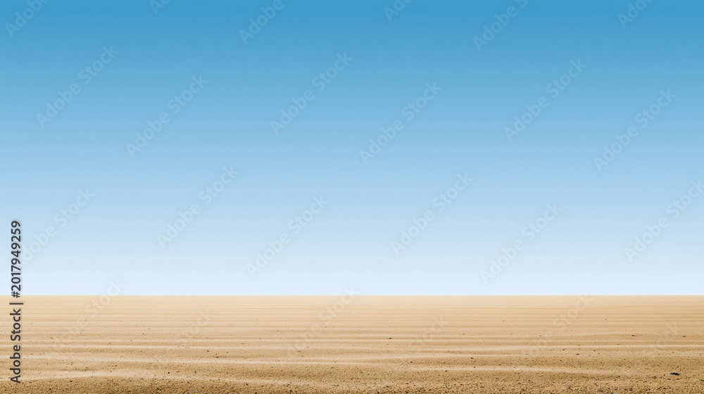 Fototapeta premium Vast, dry desert landscape under a clear blue sky with a flat horizon and no vegetation.