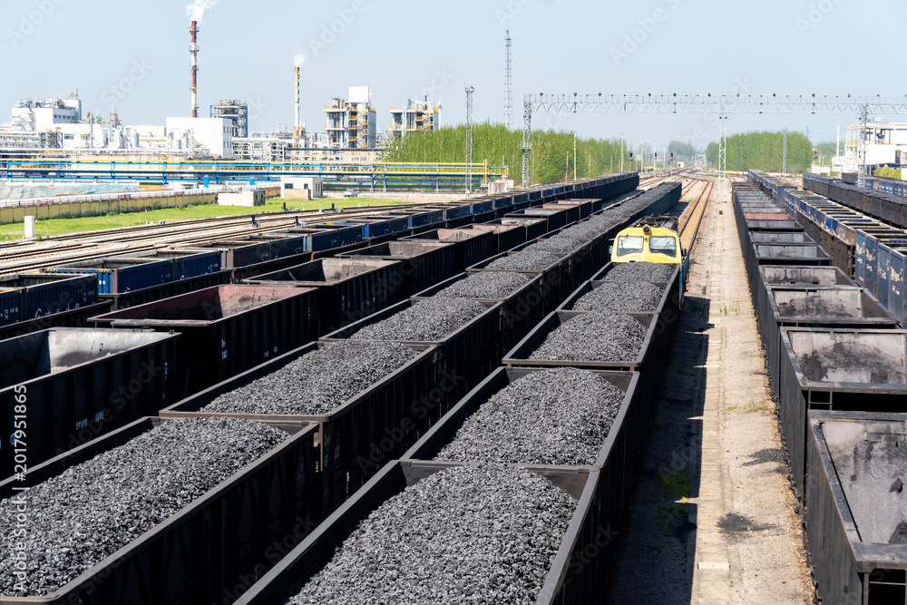 Fototapeta premium Railway coal transportation station - Freight train fully loaded with coal 