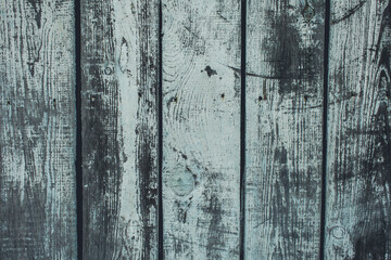 Weathered wooden planks with a blue-gray hue. The surface shows signs of aging, including cracks and texture variations. Ideal for backgrounds or rustic themes.