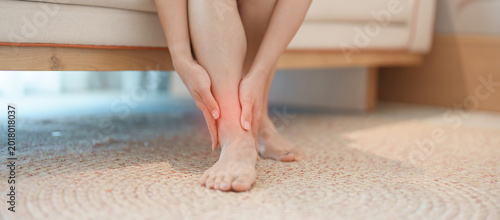 Fényképezés woman having leg pain due to Ankle Sprains or Achilles Tendonitis and Shin Splints ache