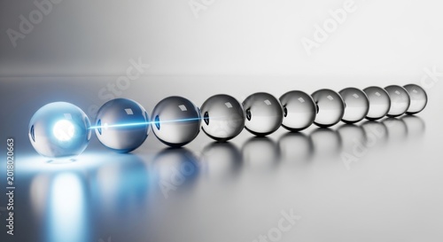 Conceptual image of a glowing sphere transmitting energy to a row of balls