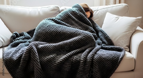 Person Hiding Under Grey Blanket On Sofa