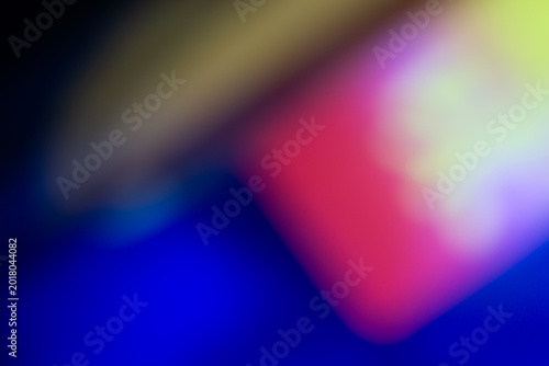 Vibrant abstract background with smooth neon gradients in blue, magenta, and yellow. Soft bokeh light leaks create a modern, artistic, and colorful digital texture.