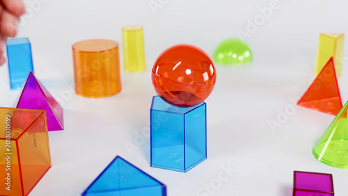Canvastavla Red Sphere Balanced on Blue Hexagonal Prism with Other Geometric Shapes