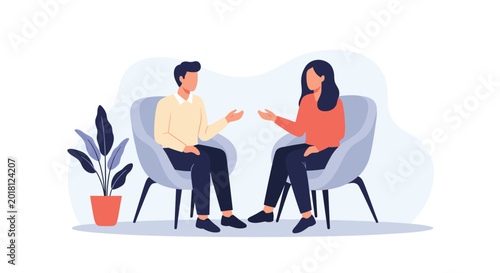 Man and woman sitting in comfortable armchairs having a friendly conversation in a relaxed environment with a plant.