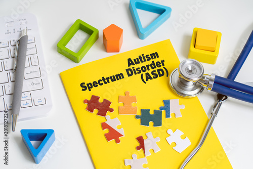 Autism spectrum disorder ASD concept with puzzle pieces and stethoscope on office desk