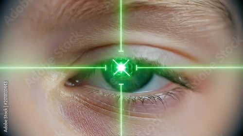 Close-up view of a blue and brown eye with green targeting crosshairs