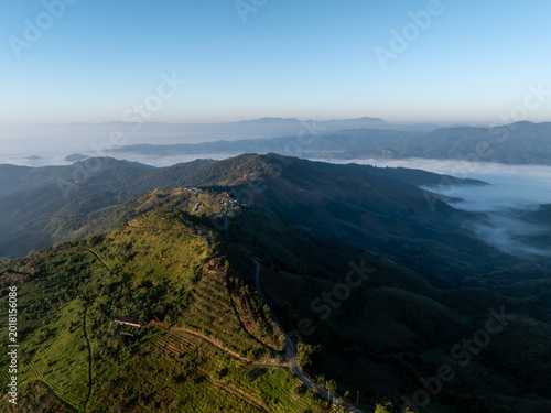 Canvastavla Sunlit Mountain Ridges Descending Into A Misty Valley Landscape During Early Mor