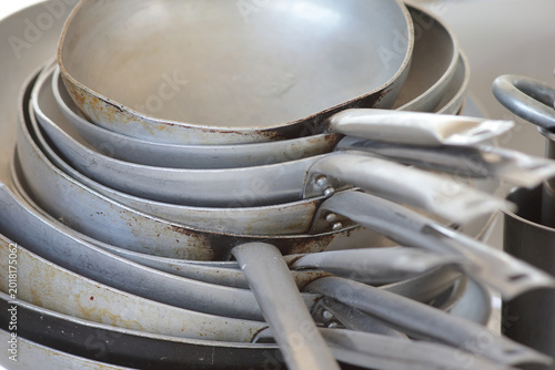 Stack of Used Aluminum Frying Pans in a Professional Restaurant Kitchen