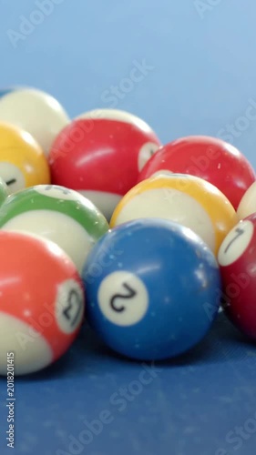 Vertical video: Pulling camera revealing ball cluster shifting focus on blue felt showing blue 2