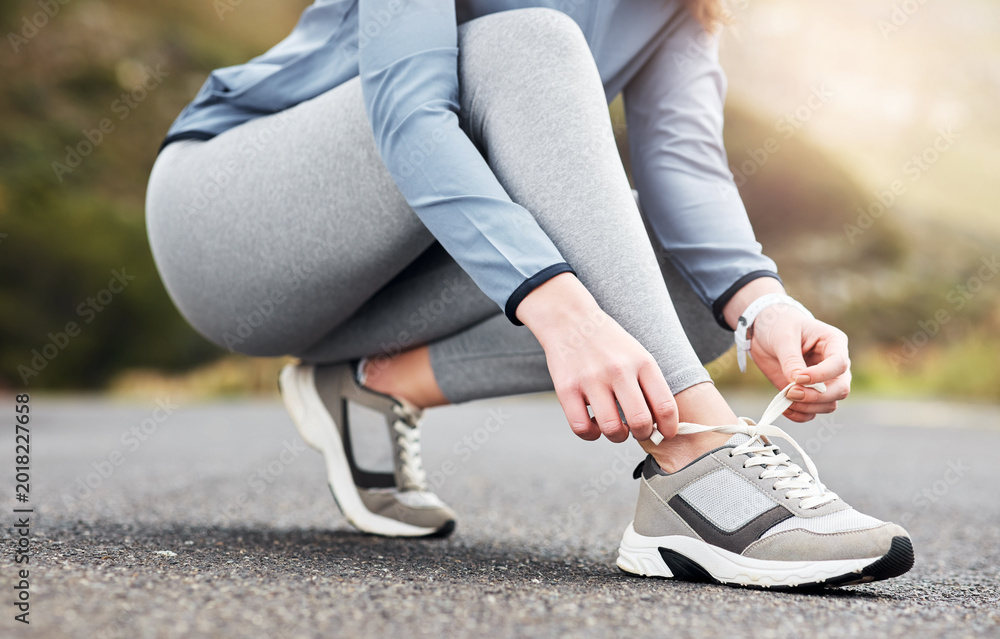 Naklejka premium Hands, tying laces and shoes of runner outdoor for fitness start, health and training sneakers. Wellness, exercise and sports athlete and feet of person in street for getting ready and preparation