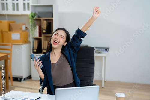 Fotografie Overjoyed charming excited woman business woman worker using smartphone