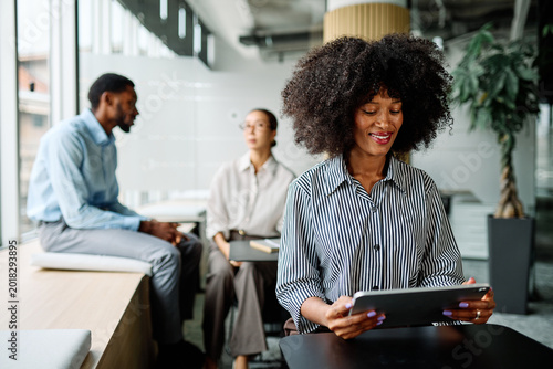 Portrait of a smart young businesswoman using a tablet computer in the office or classroom. Startup and succesful business concept or education and student concept