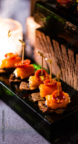 Fotografie Pumpernickel bread sandwich snack with cured smoked salmon and fresh avocado ser