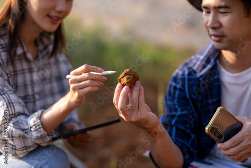Obraz na plátně Scientists researching soil sample in field studying geology