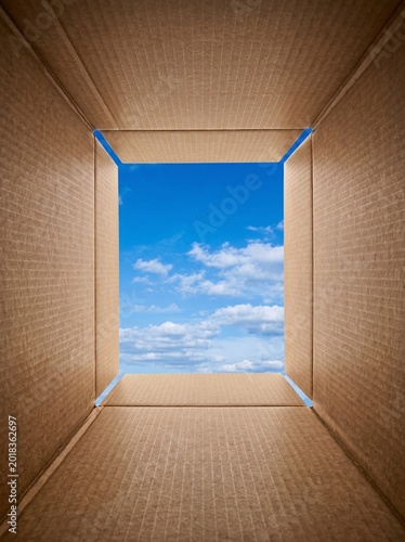 Looking out from the bottom of a cardboard box at clouds