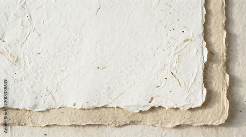 Handmade paper texture with torn edges, white and beige layers