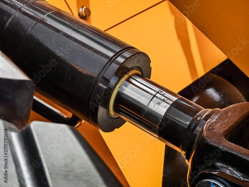 Bild auf Leinwand Close up view of hydraulic cylinder showing metal and rubber components at const
