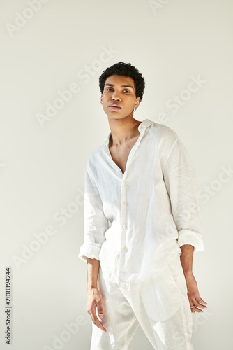 Φωτογραφία Handsome young man dressed in white linen exudes confidence in bright studio spa