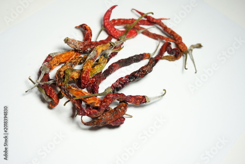 Quadro em tela Close up of moldy dried red chili peppers on white background