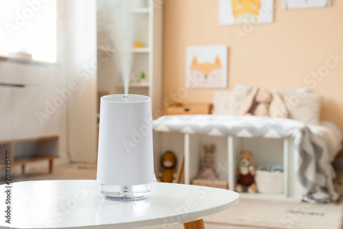 Air humidifier on table in ...
