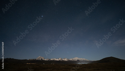 Person Watching the Milky Way Over Yala Snow Mountain, Tibetan Plateau Night Adventure