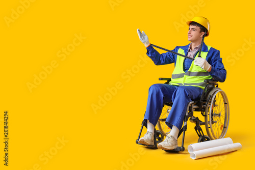 Male worker in wheelchair w...