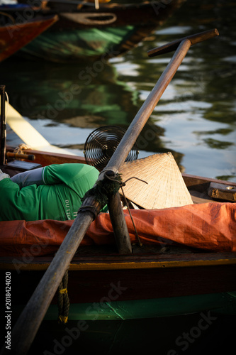 A boatman taking a nap on a traditional boat