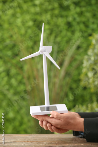 Businessman holding wind tu...