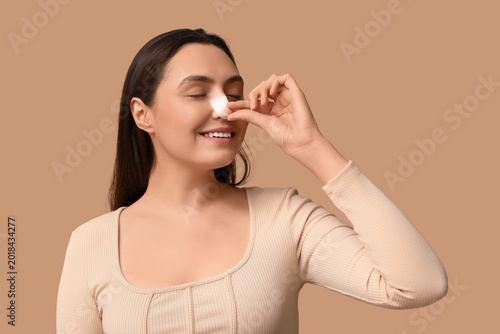 Young woman with bandaged n...