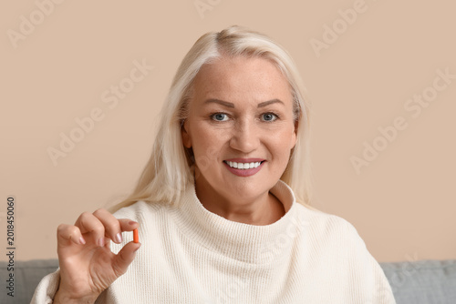 Smiling mature woman holdin...