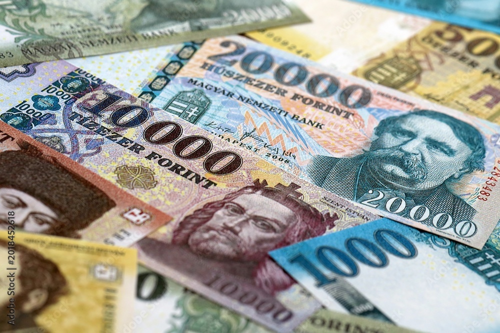 Obraz premium Hungarian forint money bills pile on table. Hungary banknotes of HUF currency close up.