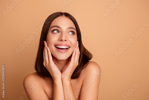 Bilde på lerret Happy smiling woman with flawless skin posing against a beige background showcas