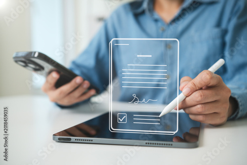 фотографія Digital document signing on tablet person using stylus for electronic signature approval secure online contracts paperless workflow and modern business verification