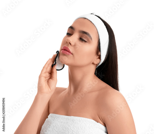 Young woman removing makeup...