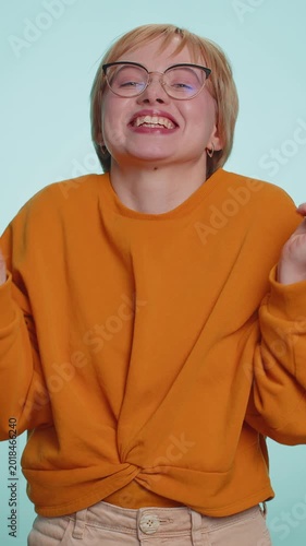 Woman in glasses showing wasting, throwing money around, more tips, big profit, winning lottery jackpot, successful shopping payment purchase, cashback. Blonde lady isolated on blue studio background