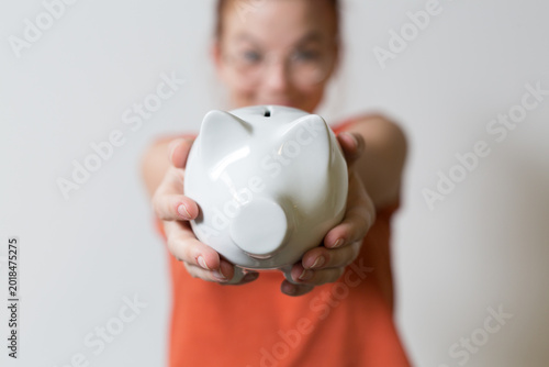 A person holds a white pigg...