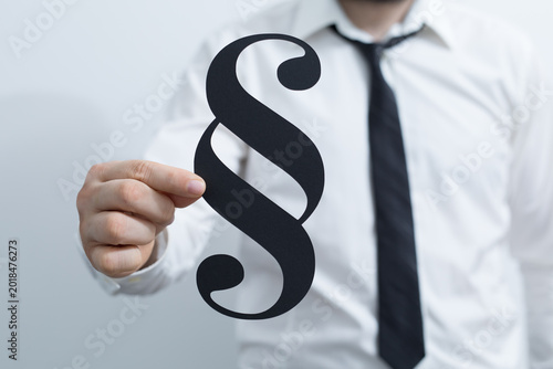 A person in a suit holds a ...