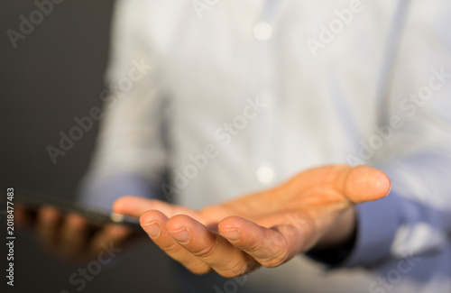 Tableau sur toile Close-up of a man's hand, offering, giving, or holding an object