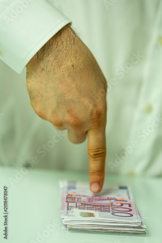 A hand with a finger pointi...